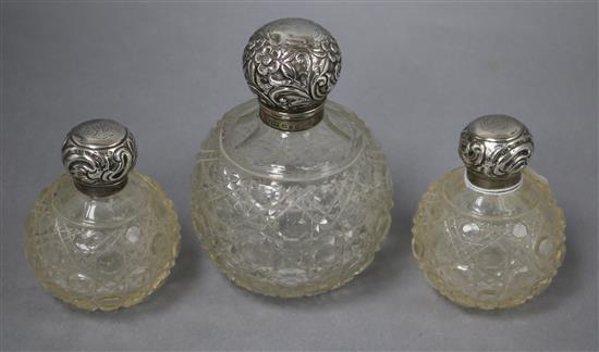 A pair of Edwardian silver mounted cut glass scent bottles and a larger late Victorian scent bottle, largest 14.9cm.